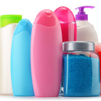 Plastic bottles of body care and beauty products isolated on white SLES